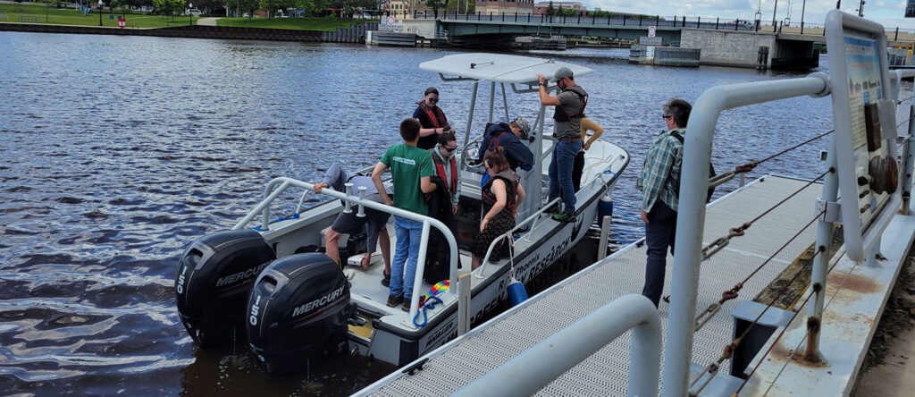 Students board the UW-Green Bay Whaler to explore freshwater systems in Manitowoc